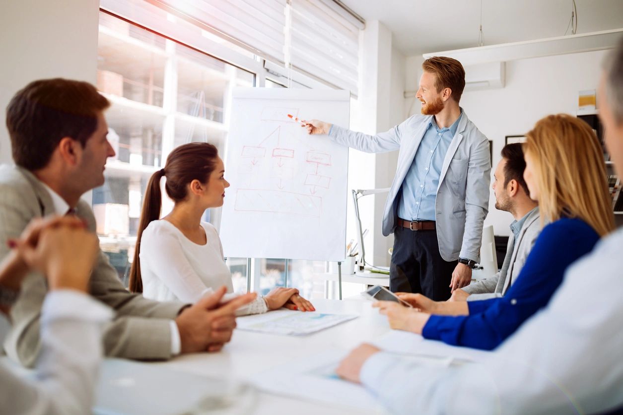 A man is giving a presentation to his colleagues.